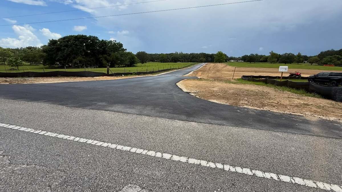 The same Dade City entrance finished — fresh asphalt