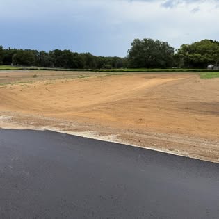 Graded dirt shoulder along fresh asphalt