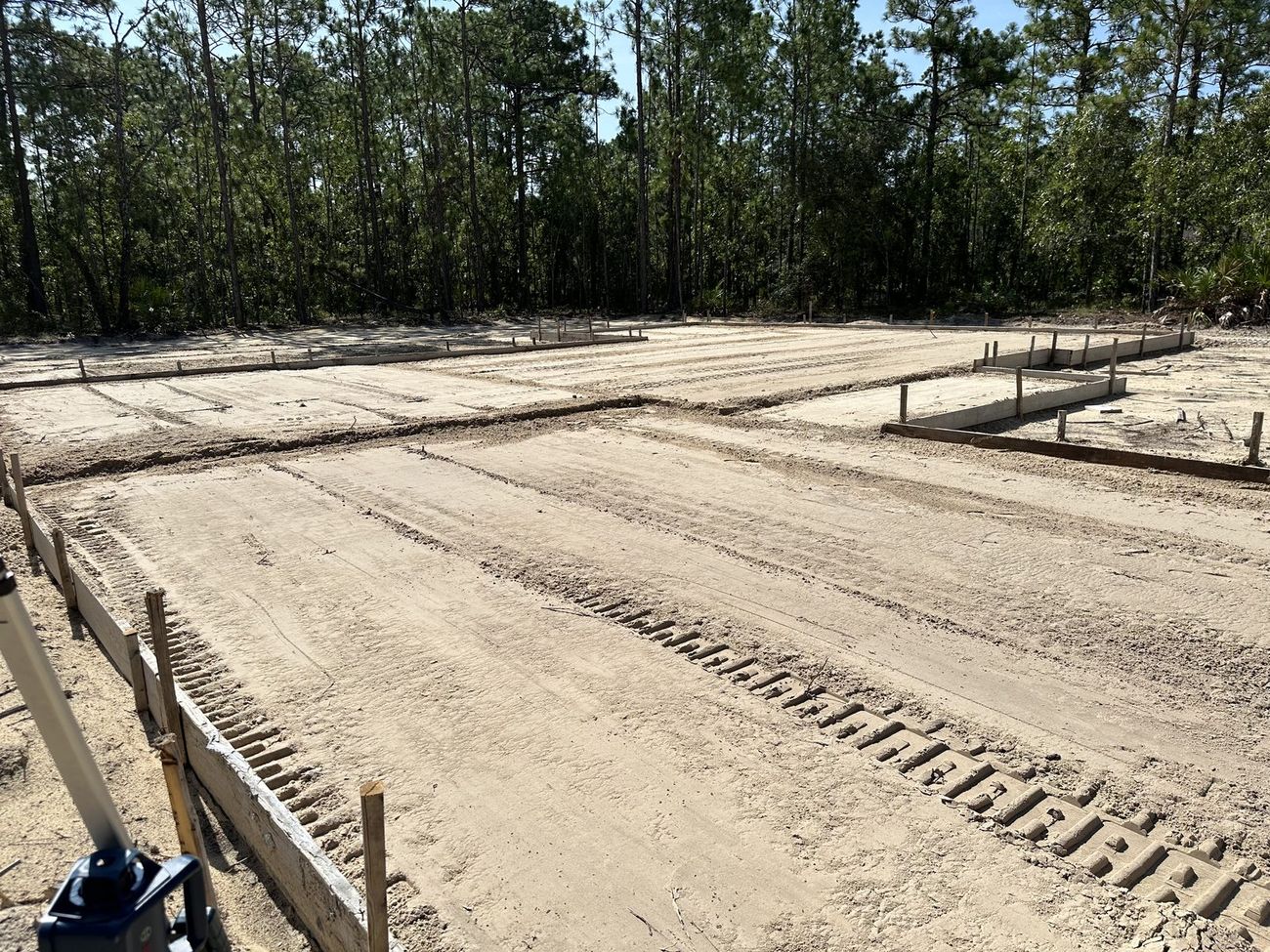Building pads formed and staked on a cleared homesite