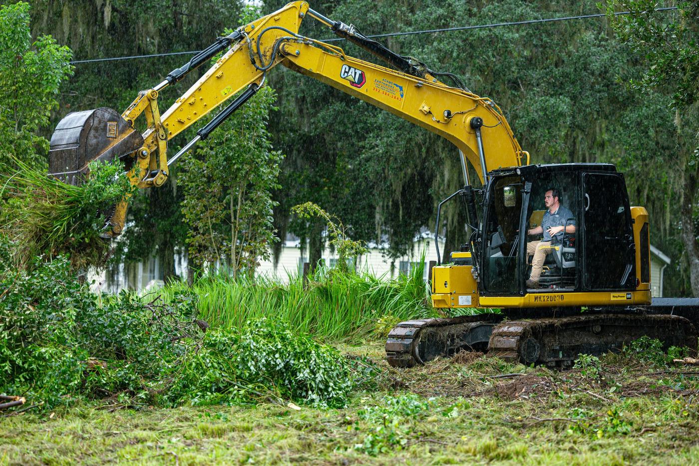 Sam Adams running the CAT excavator along a brush line