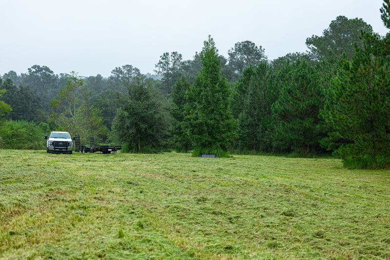 Cleared, cut-down field with the work trucks staged