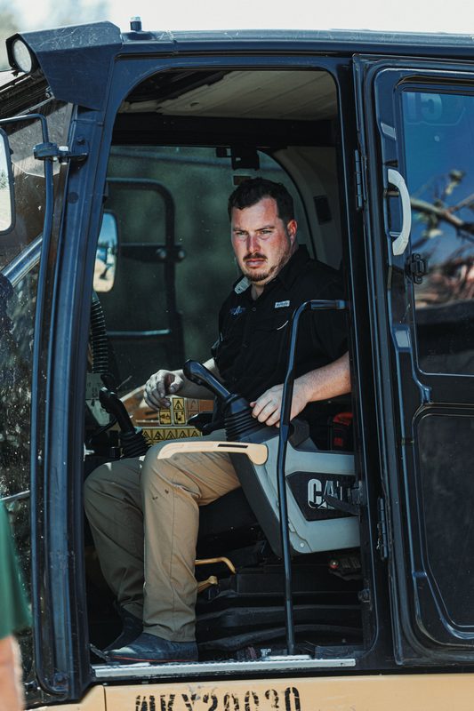 Sam Adams in the cab of his CAT excavator